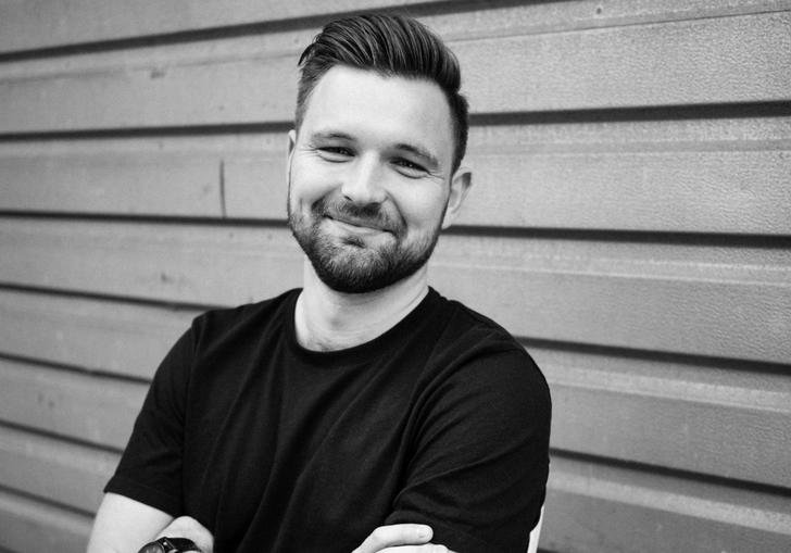 A black and white image of James smiling joyfully