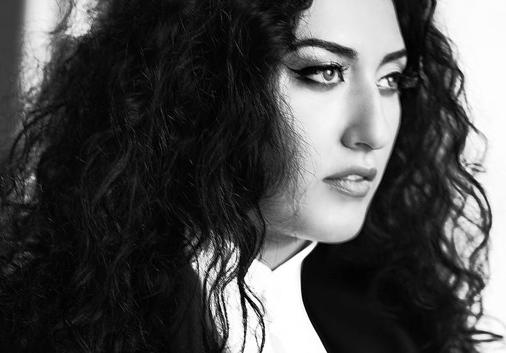A black and white image of Anita gazing into the middle distance, her eyeliner on fleek