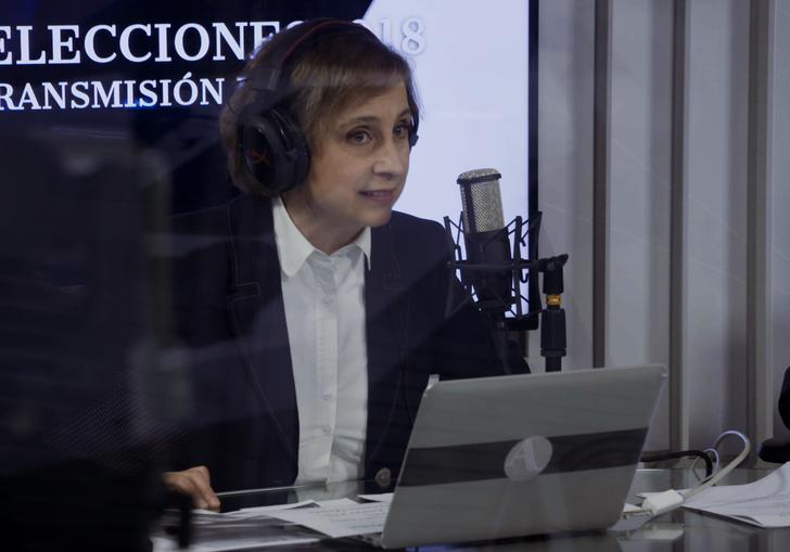 A woman on-air in a radio studio