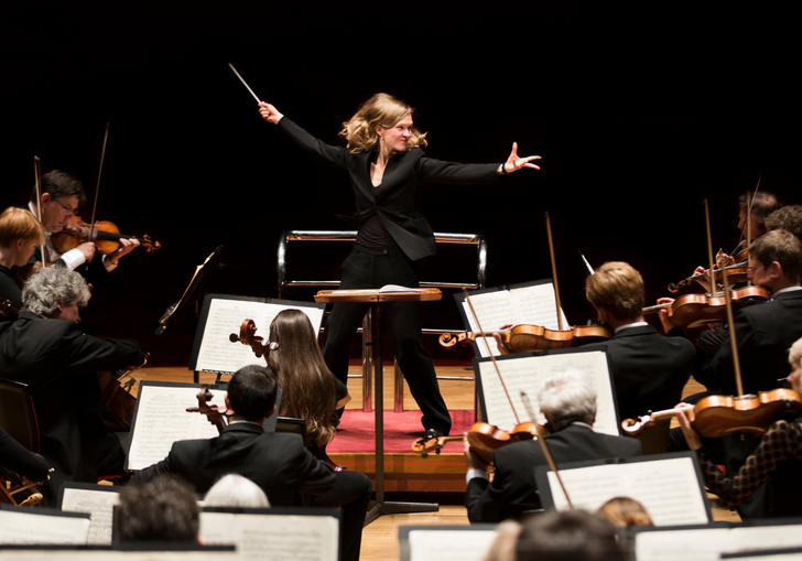 An image of Migra Gražintė-Tyla conducting the City of Birmingham Symphony Orchestra with great vigour