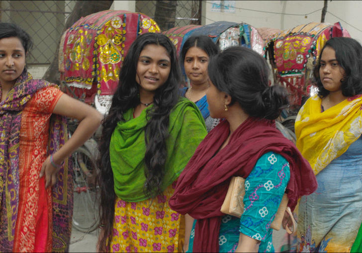 group of Bangladeshi women walk down the street 