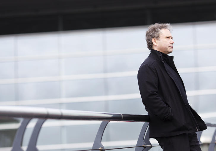 Richard Edgarr leaning on a bridge gazing into the middle distance 