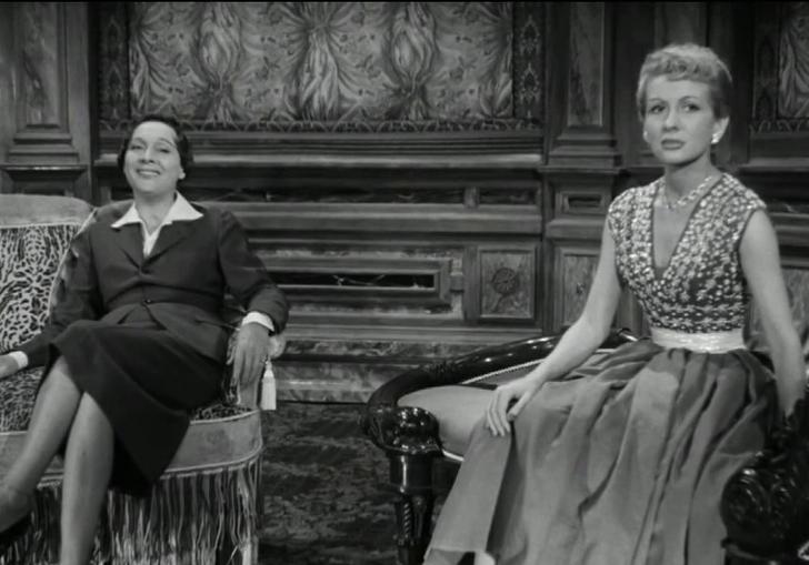 two women sitting in a lounge-like room