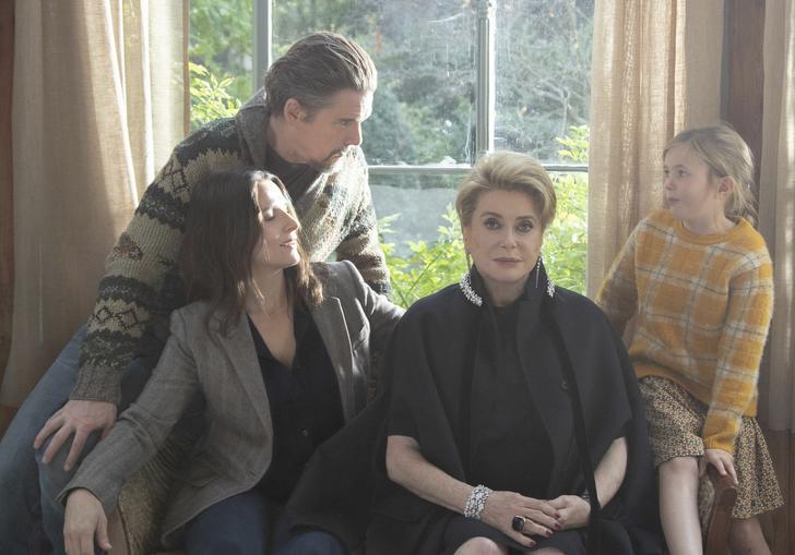 A family consisting of two women, a man, and a young girl