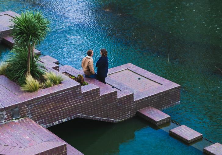 a couple overlooking the barbican lakeside