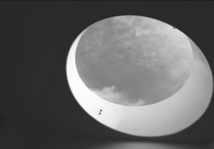 black and white photo of a ceiling window showing the sky
