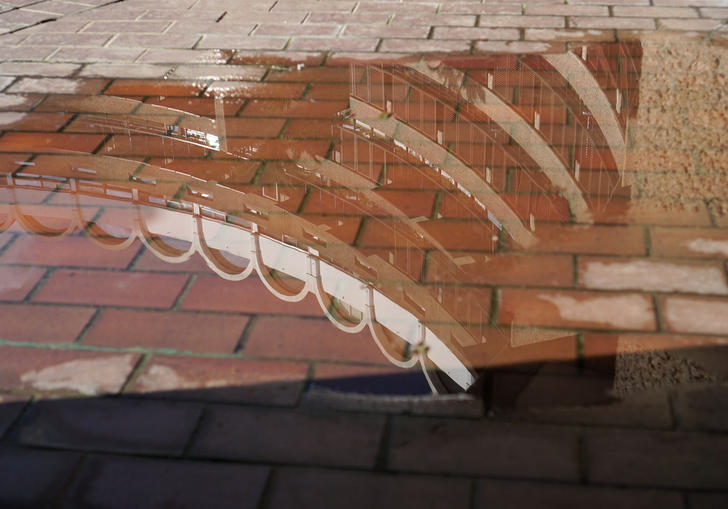 reflection of the barbican in a puddle 