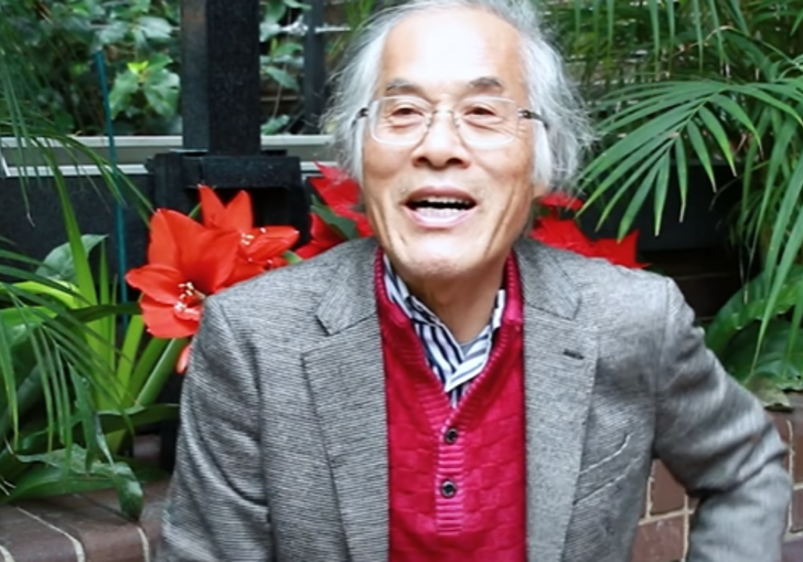 photo of terunobu fujimori smiling against some plants