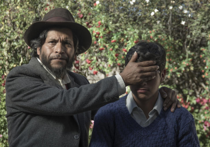 A man covers a small child's eyes