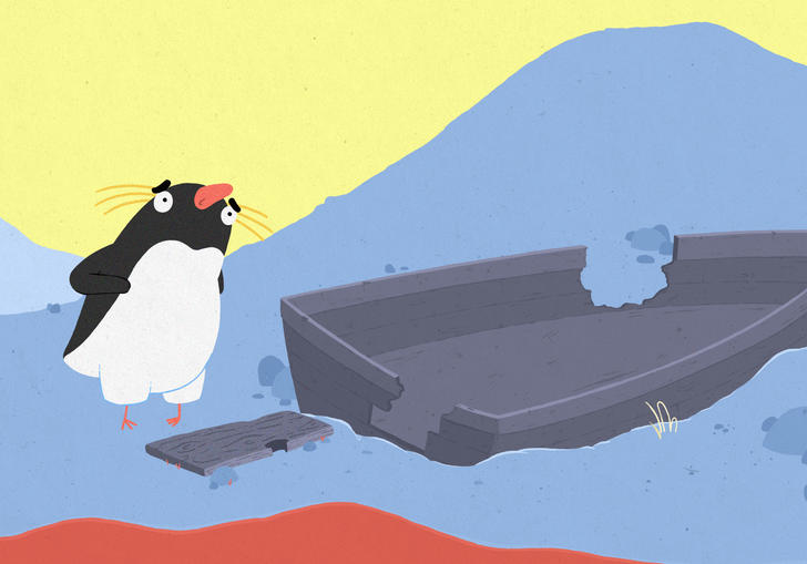 A penguin walking around in the water next to a boat