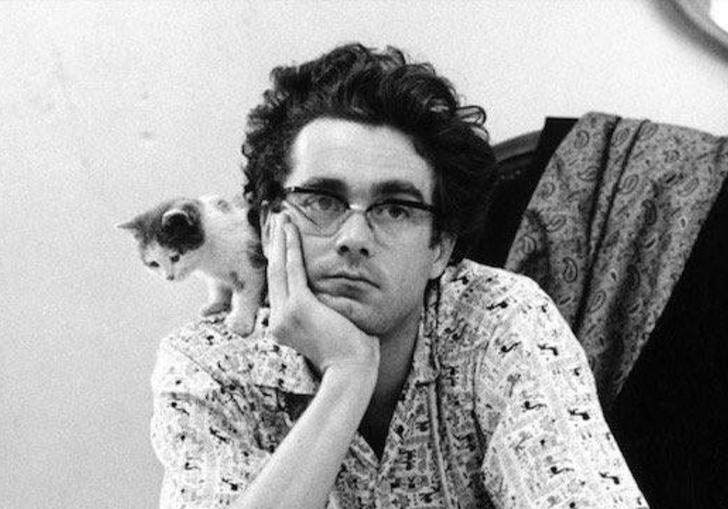 A portrait of Paul Motian with a kitten on his shoulder