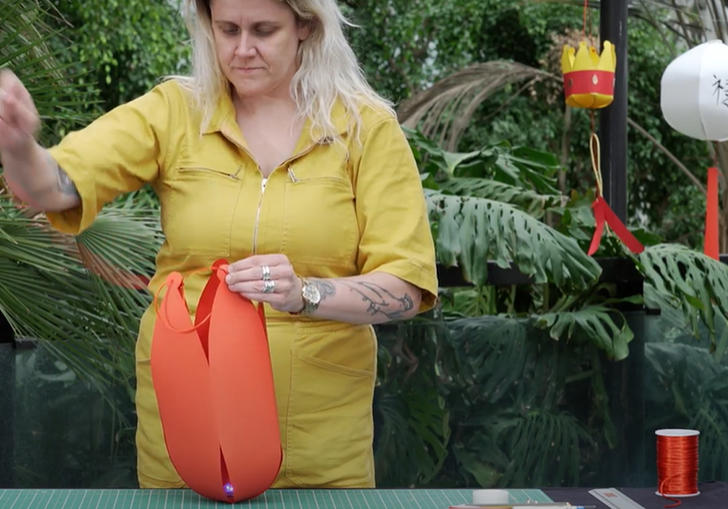 Woman in conservatory making a lantern