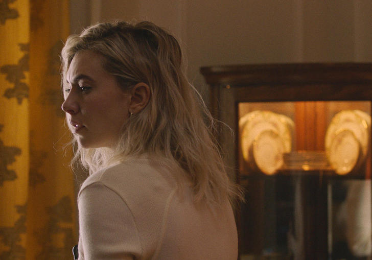 Vanessa Kirby sitting in a drab room