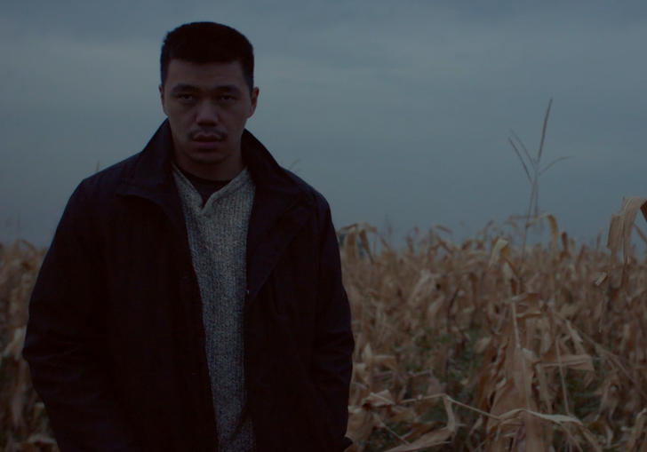 a man standing in a field of corn