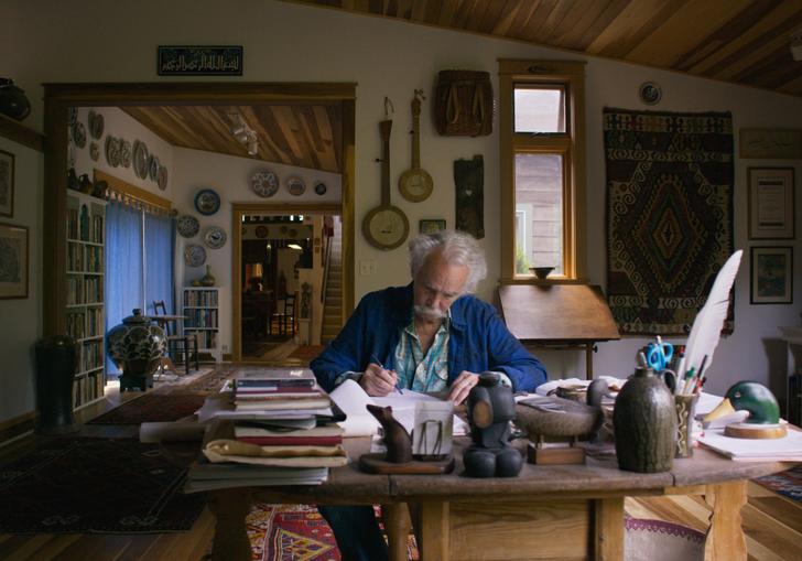 Henry Glassie sit in his office surrounded by artifacts