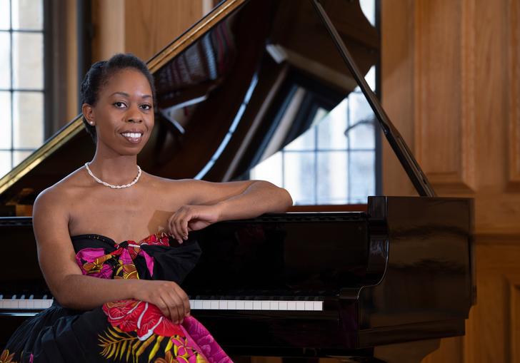 Samantha Ege sitting at a grand piano