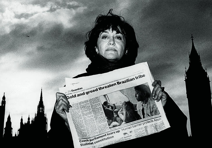 A woman holding a newspaper