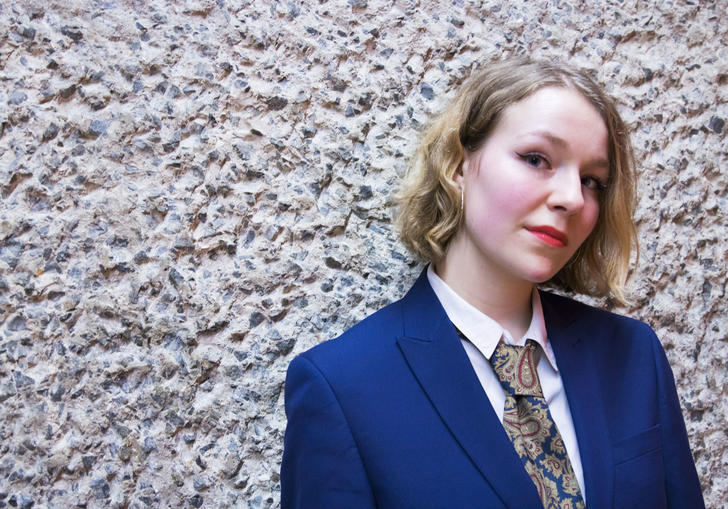 photo of annie hayter standing in front of a wall