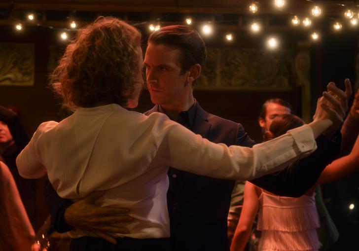 a couple ballroom dance intimately in a club