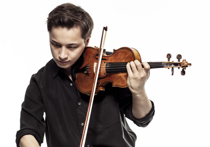Johan Dalene plays his violin, looking down at the ground