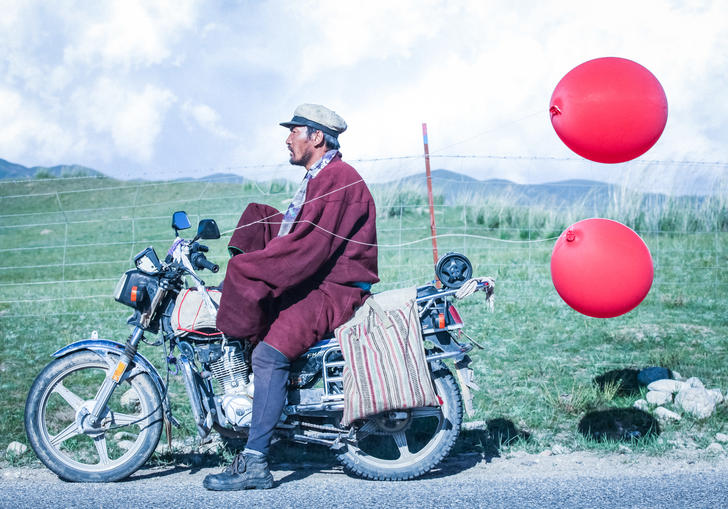 Man on motorbike with balloons