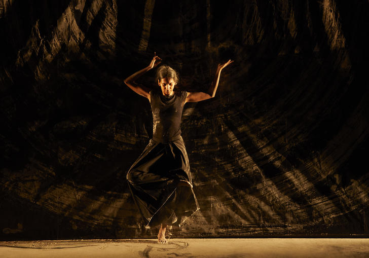 Woman dancing on stage with ash