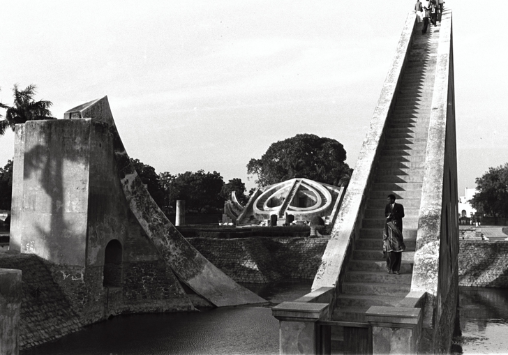 A black and white image of a large triangle sculpture 