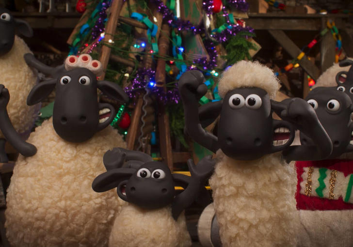 A still from Shaun the Sheep: The Flight Before Christmas - a group of sheep around a Christmas tree