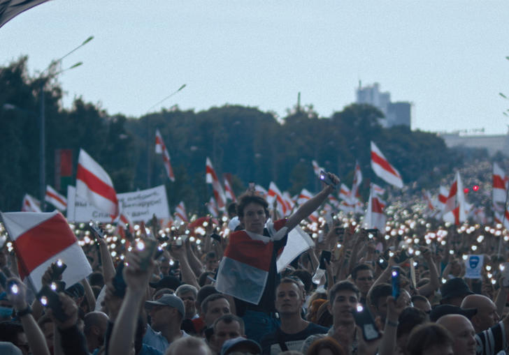 A crowd of people in Belarus waving the countries flag