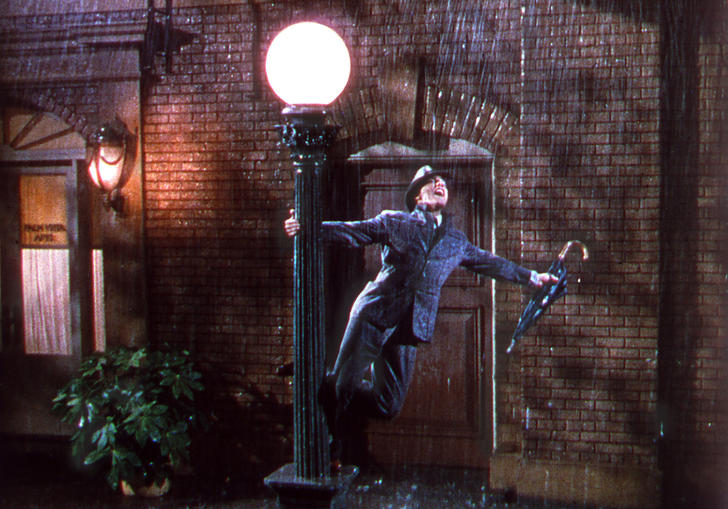 Gene Kelly standing on a lamppost in Singin' in the Rain