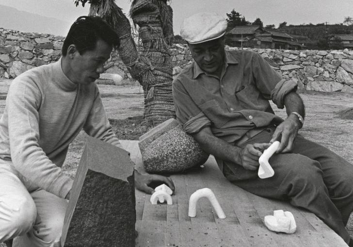 Isamu Noguchi studying models with Masatoshi Izumi in Mure, Japan, c.1970s