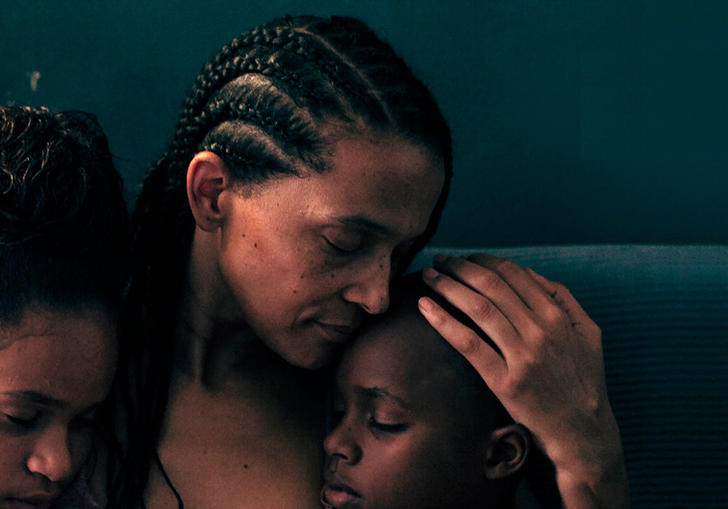 Emma hugs the two children in her care, Bantú Mama