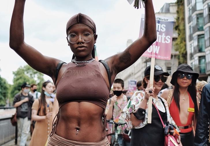 A person at Trans Pride holding a sign which says 'Not A Phase'