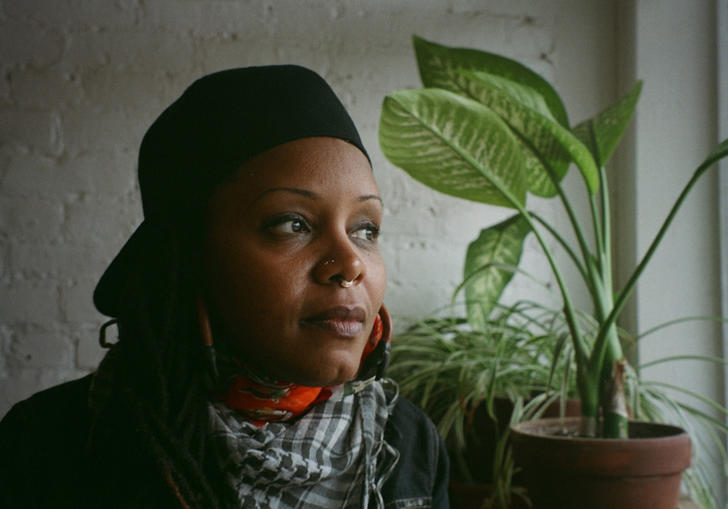 photo of Matana Roberts next to a plant