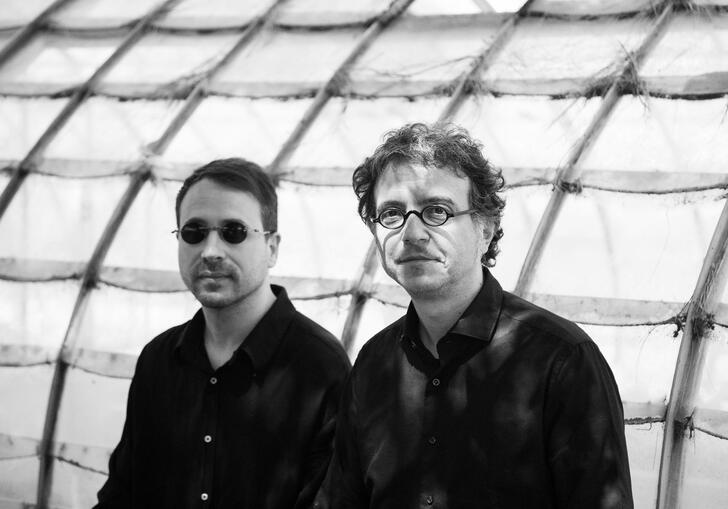 Black and white photo of Donato Dozzy and Neel wearing glasses