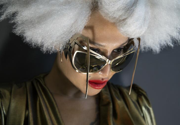 Photo of Lady Blackbird wearing statement sunglasses and hat