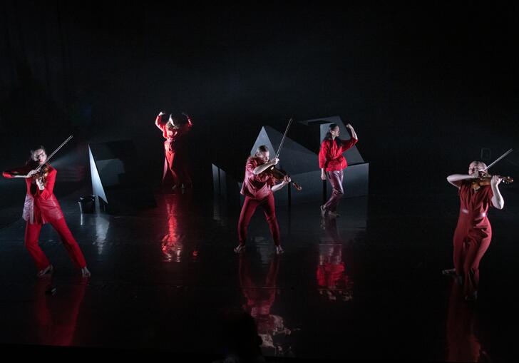 The Regazze Quartet and Lucia Lucas performing on stage in red outfits