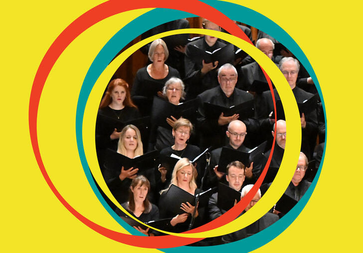BBC Symphony Chorus are in the centre of the image, surrounded by yellow BBC Symphony Orchestra branding