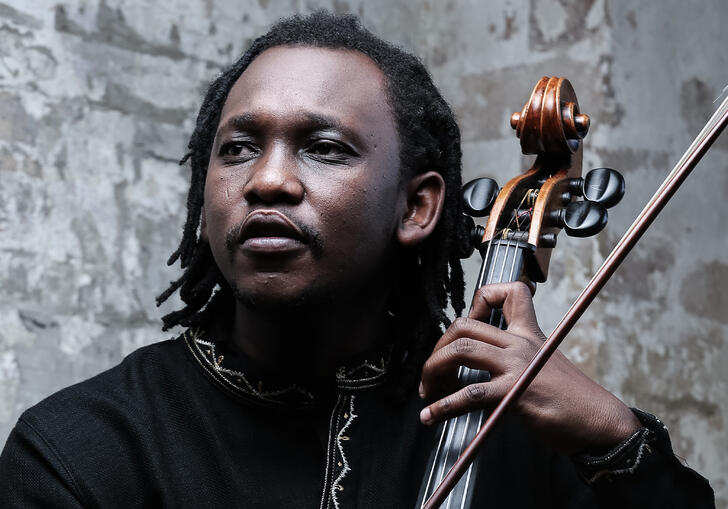 Abel Selaocoe holding his cello