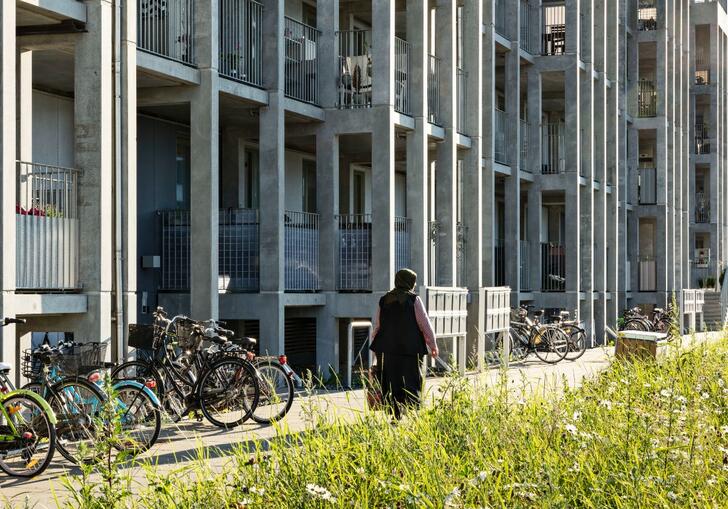 a photo of a person walking in front of a building