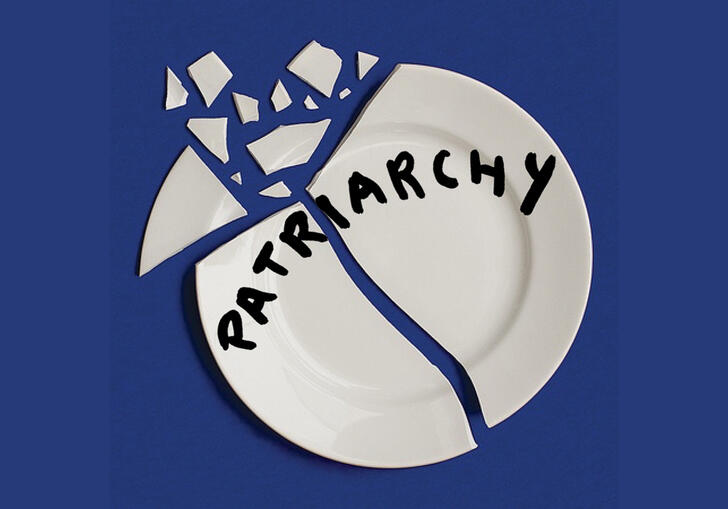 broken white plate with the word 'patriarchy' written in black. This is all on a blue background