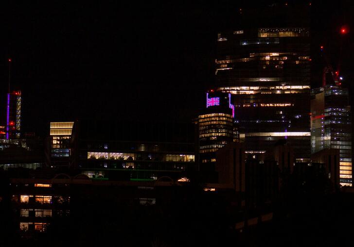 Buildings around the Barbican lit up at night time.