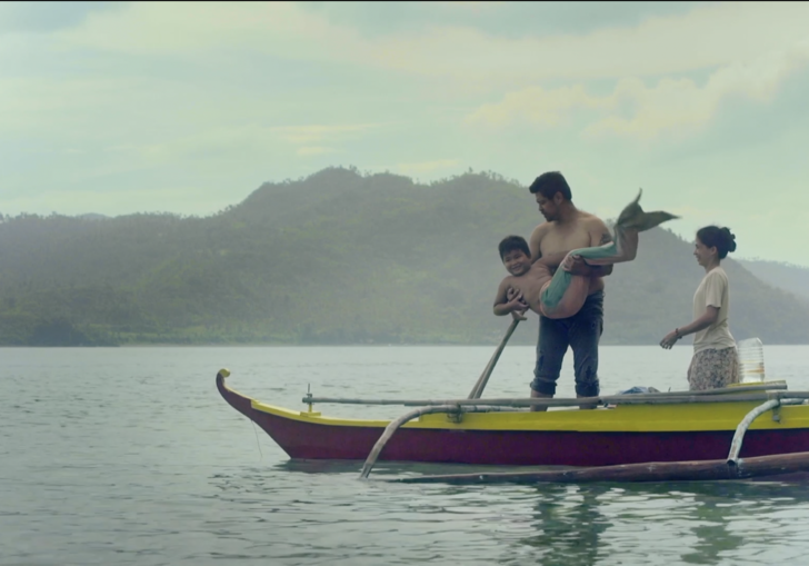 A man stands with his mermaid  