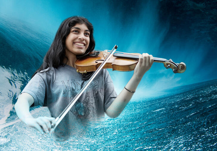 Photo of a violinist superimposed onto an ocean wave