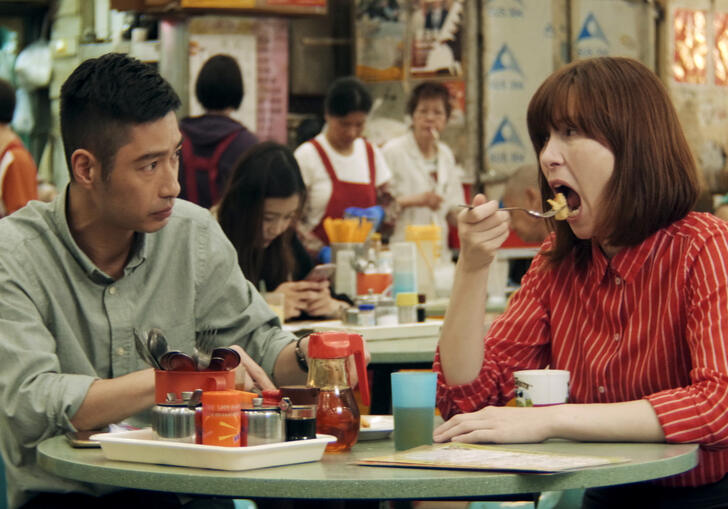 A couple eat together in a food hall