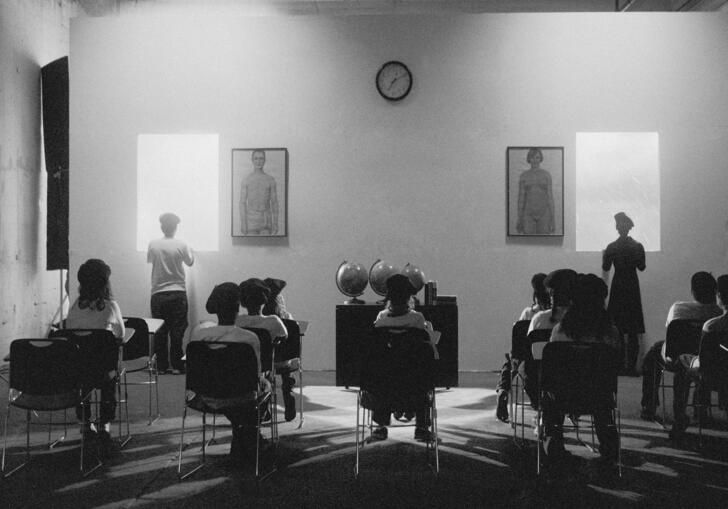 Photograph of students facing wall