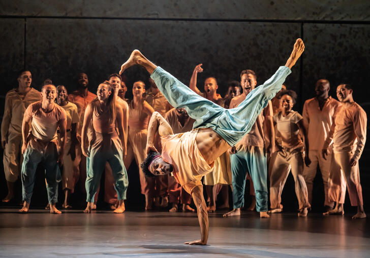 A performer break dances on a stage