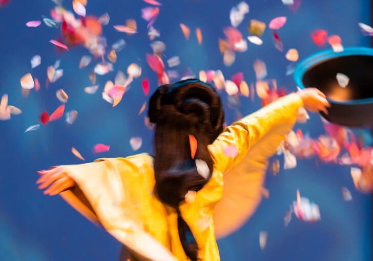 A geisha dances among colourful confetti