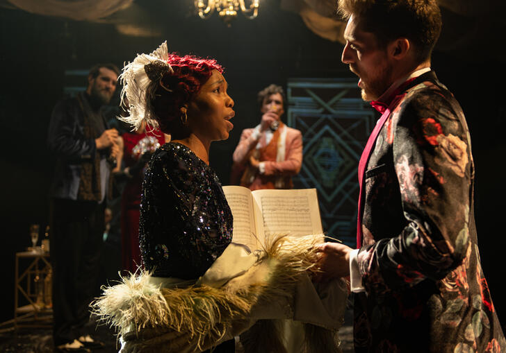 Guildhall School opera singers holding hands facing each other in period 1920s costume