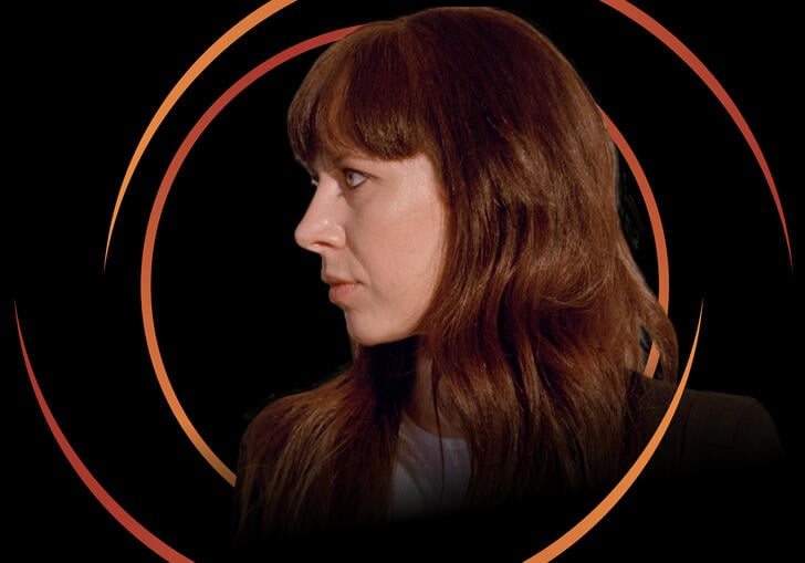 Side profile of Missy Mazzoli, with circular orange swirls around her head